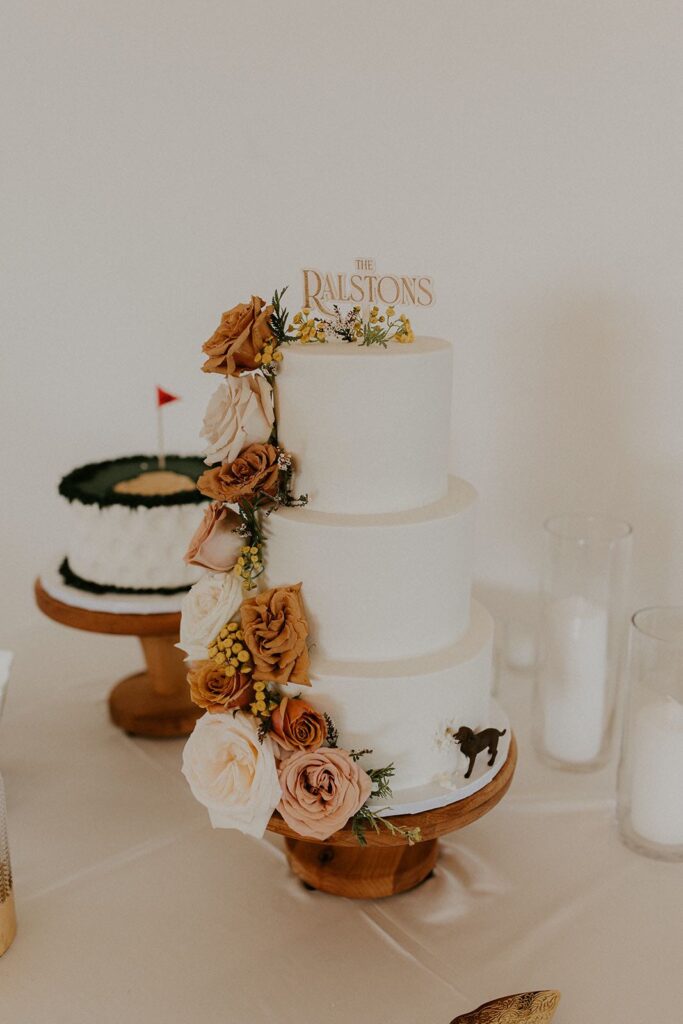 wedding cake with cascading flowers and dog figurine