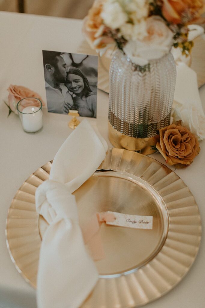 gold pleated charger with knotted napkin and place card