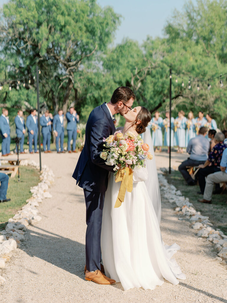 bride and groom kissing during recessional