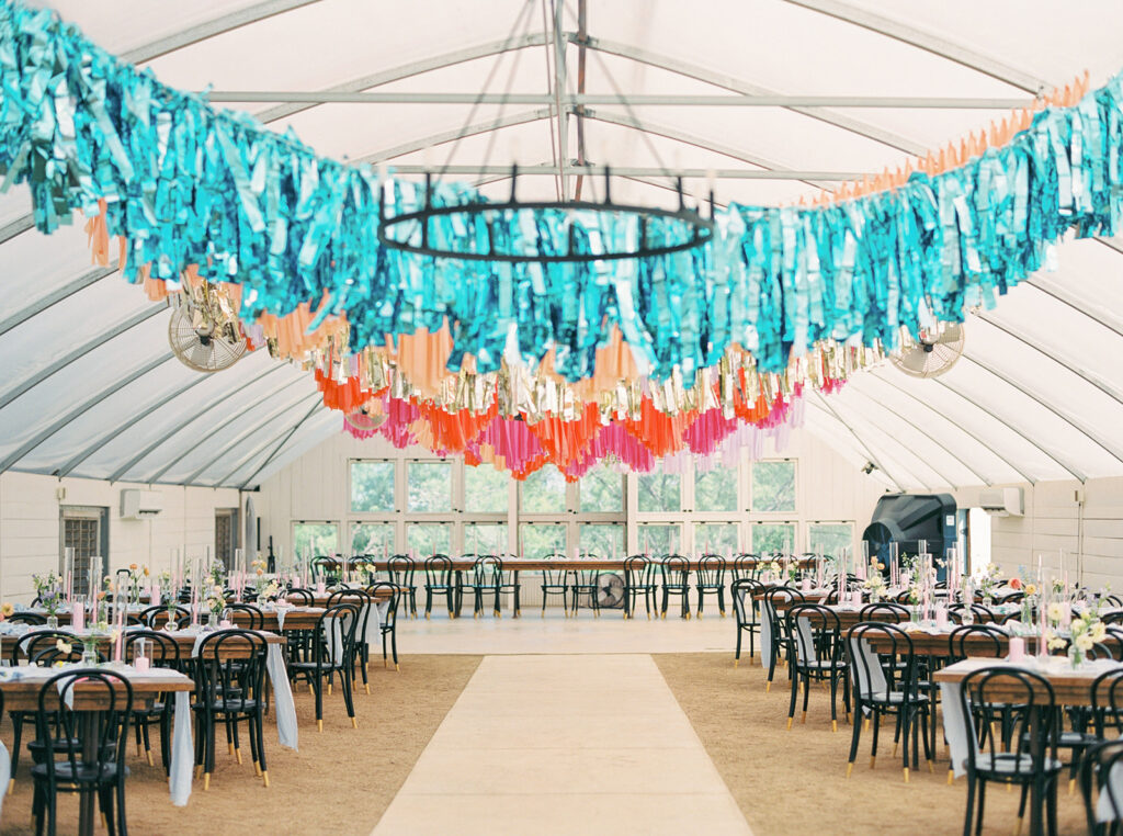 greenhouse wedding venue with colorful fringe hangings
