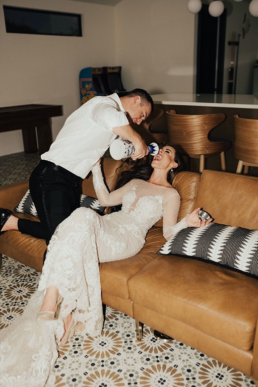Bride and groom drinking tequila in groom's suite