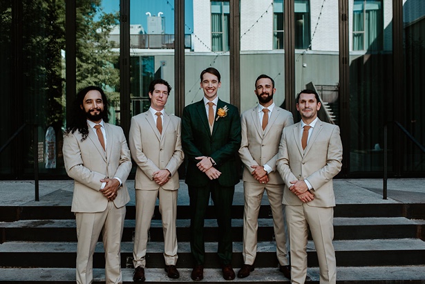 green groom suit and tan groomsmen suits