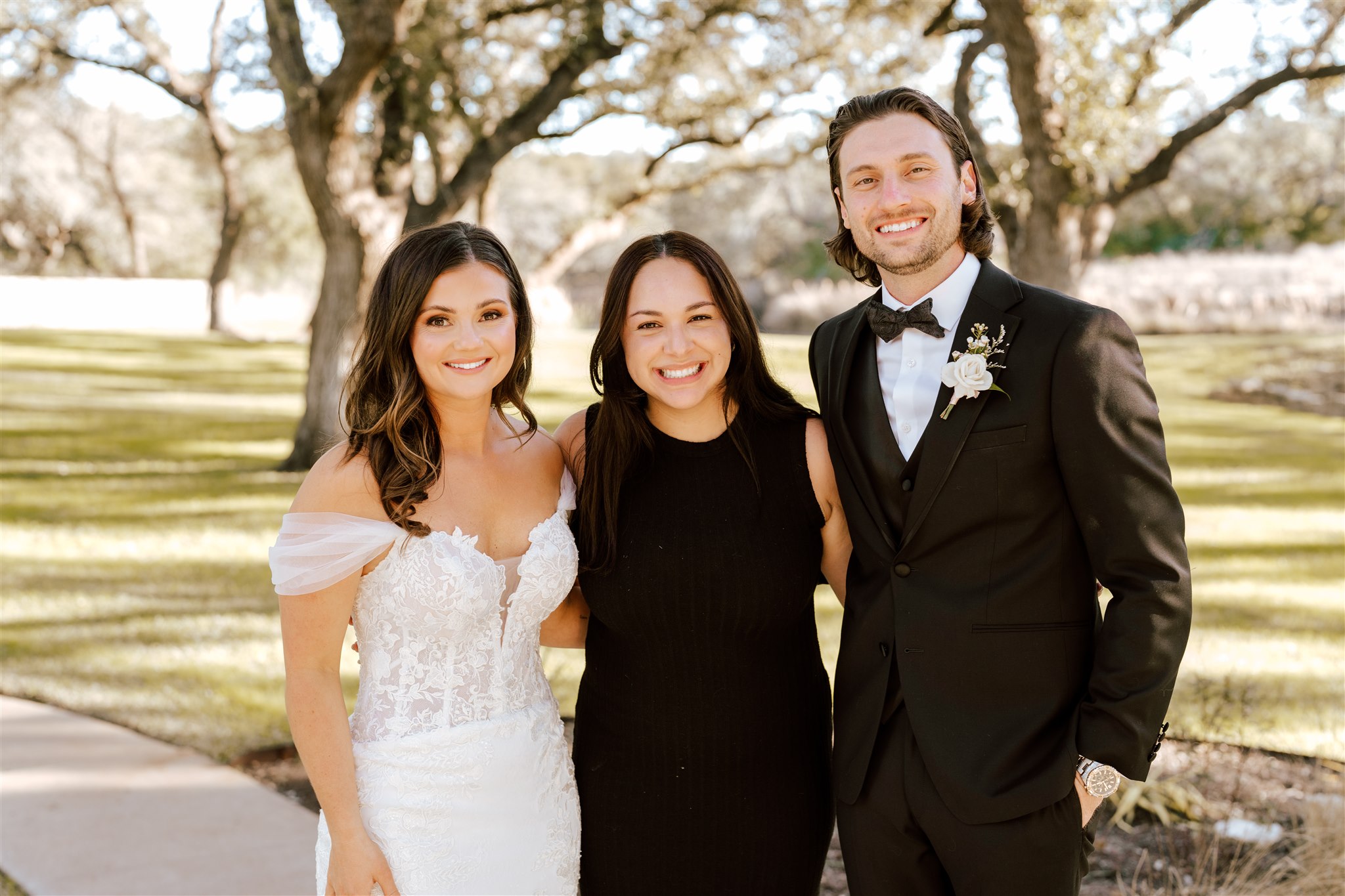 Wedding planner smiling with bride and groom