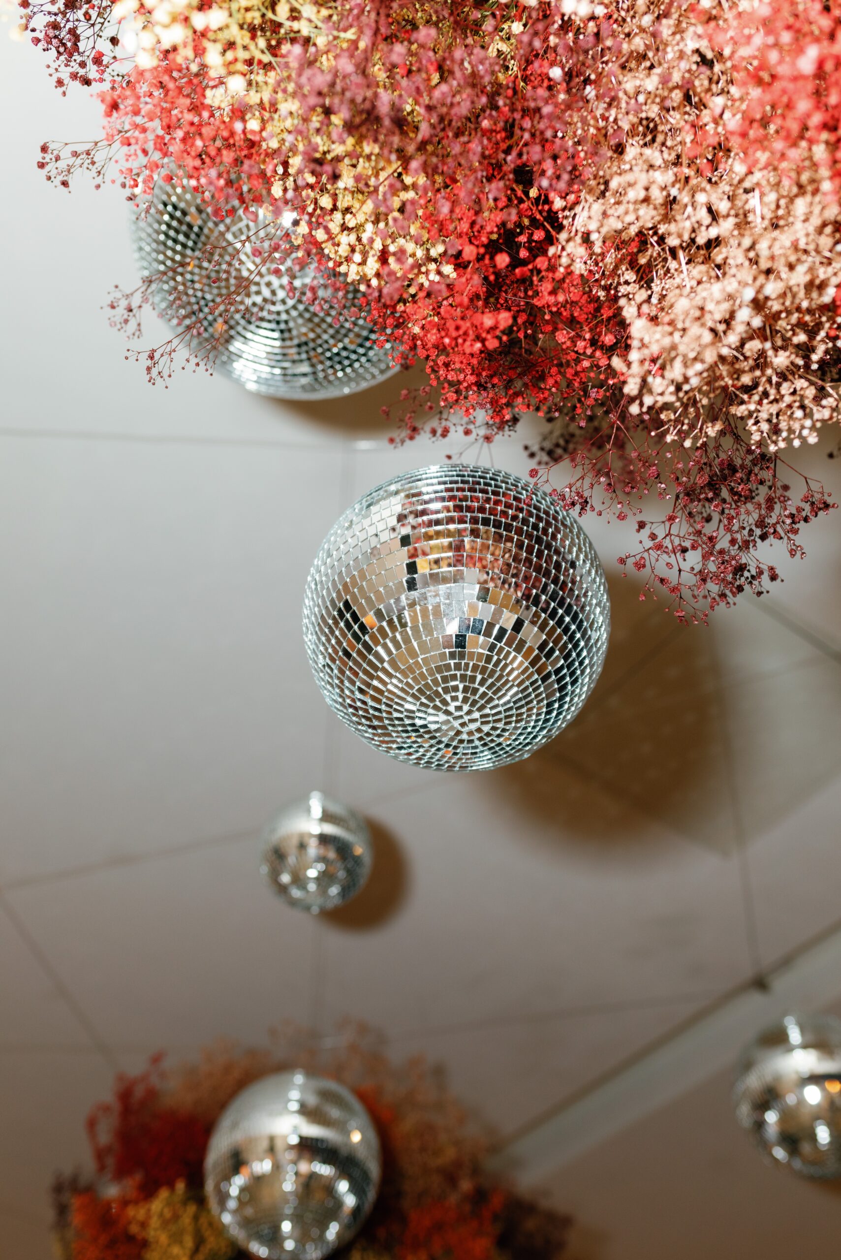 modern jewel tone wedding flowers with disco ball ceiling