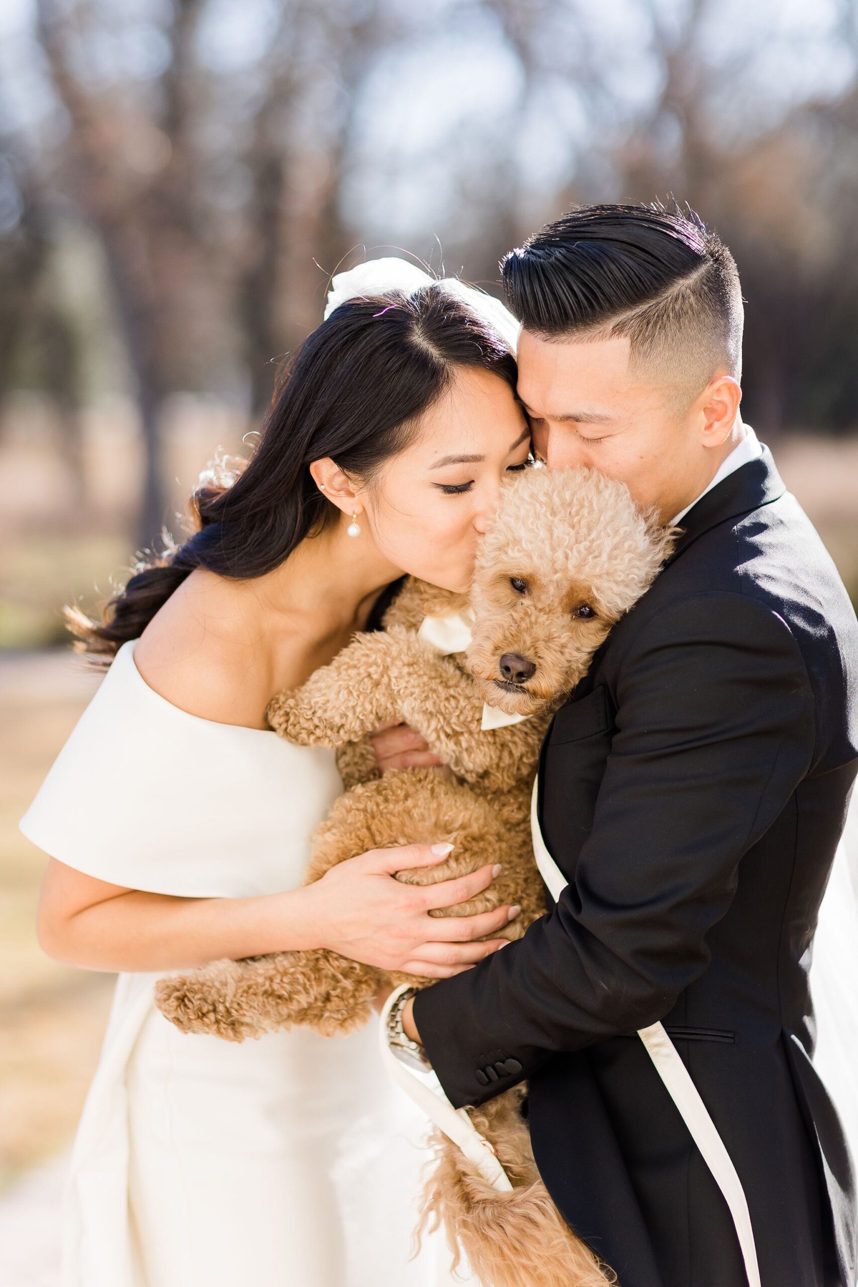 couple with their dog at their wedding
