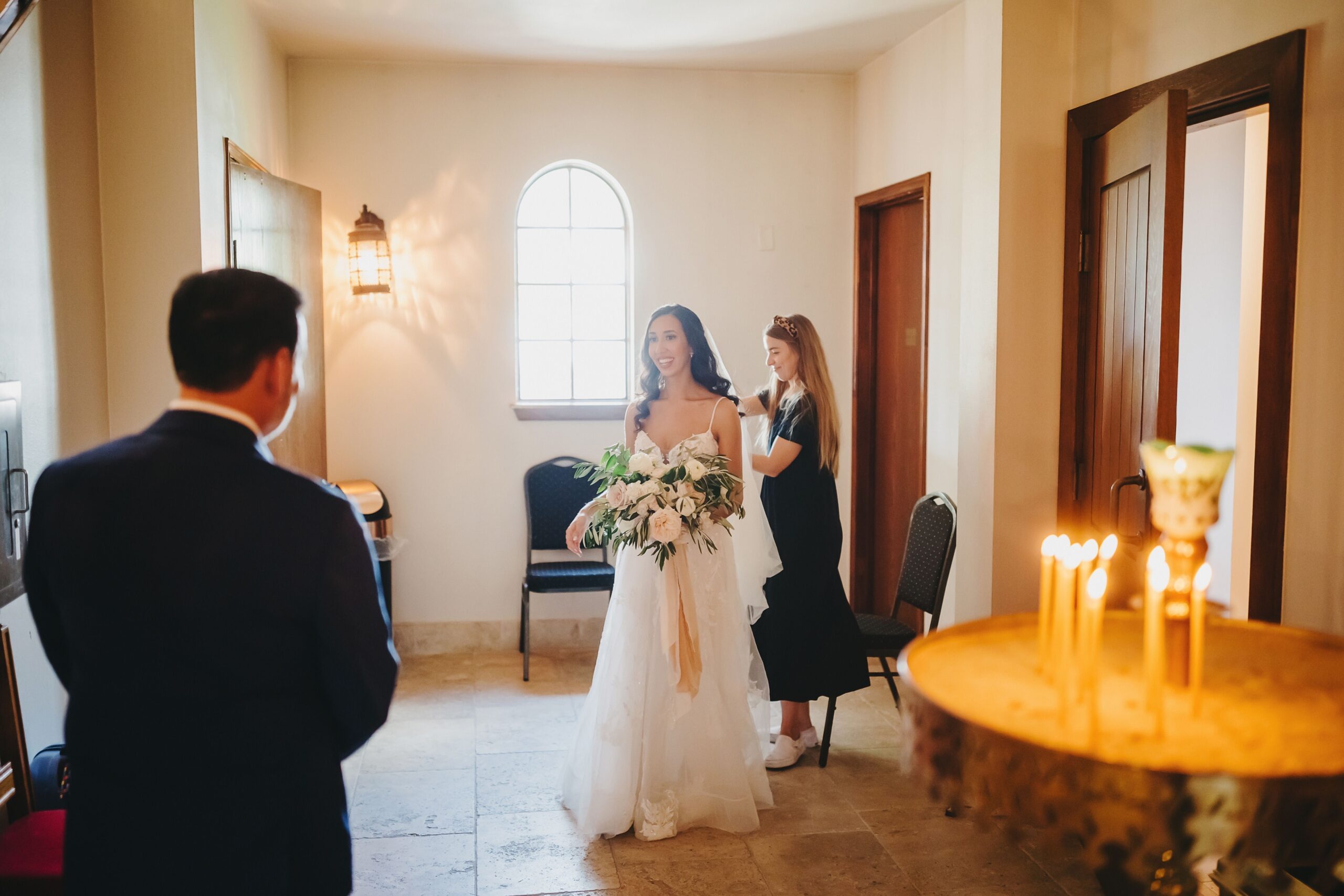 Austin wedding planner assisting bride with her veil