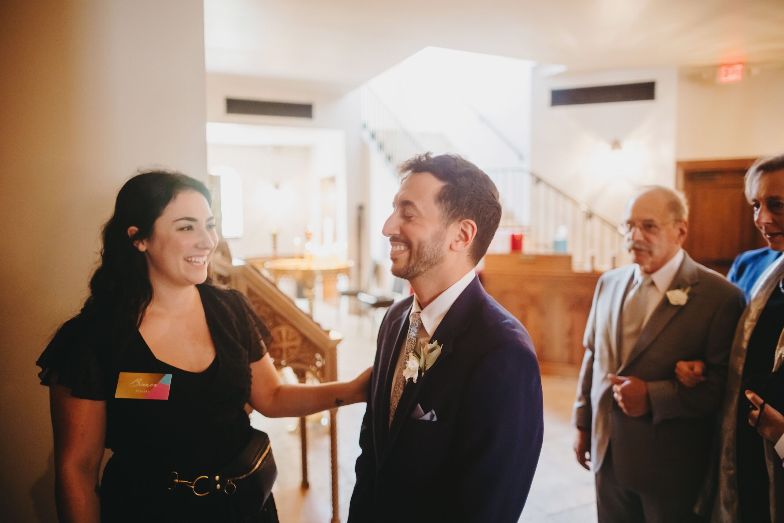 Wedding planner congratulating groom before he walks down the aisle