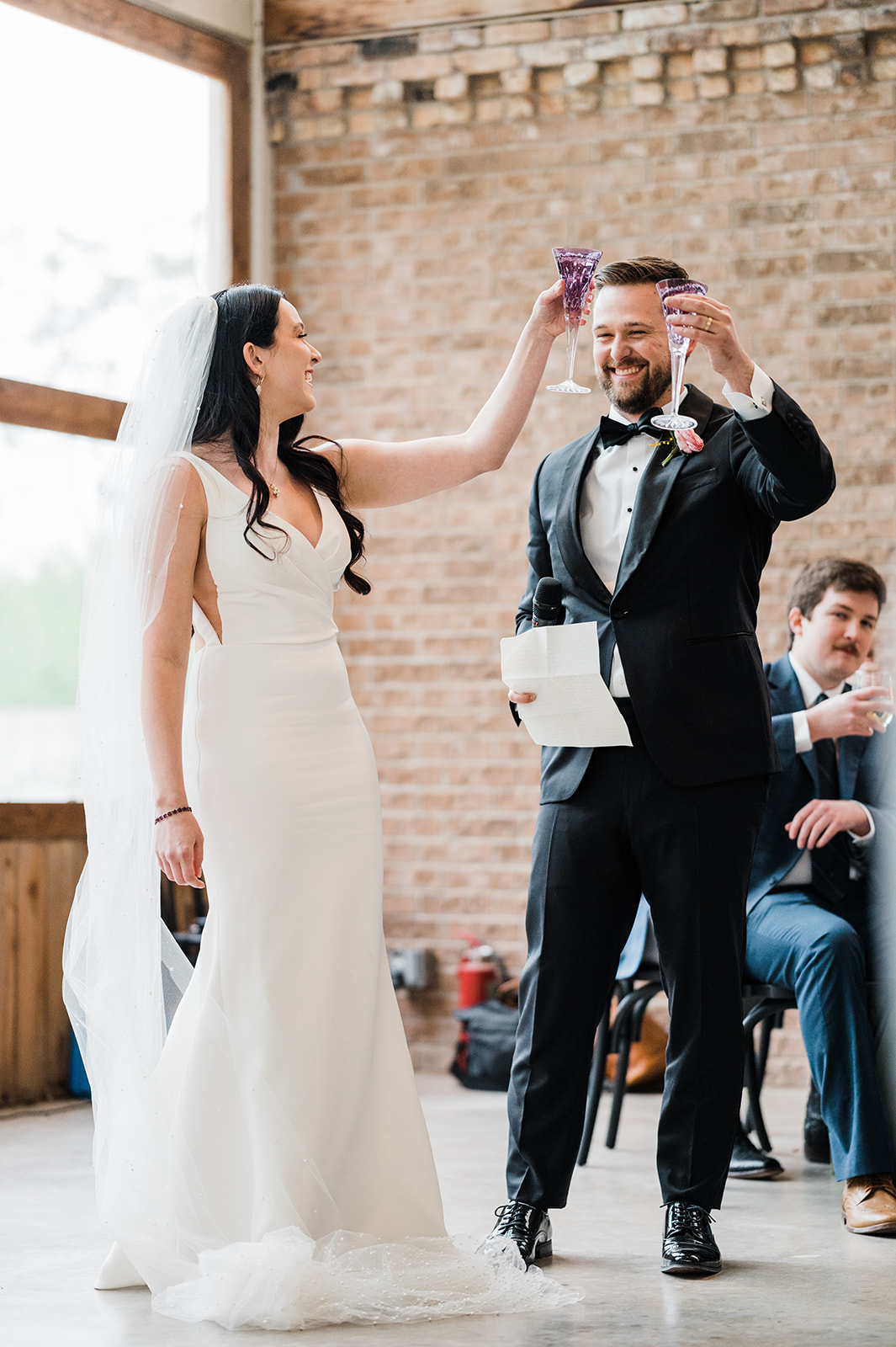 Newlyweds toasting with purple champagne flutes
