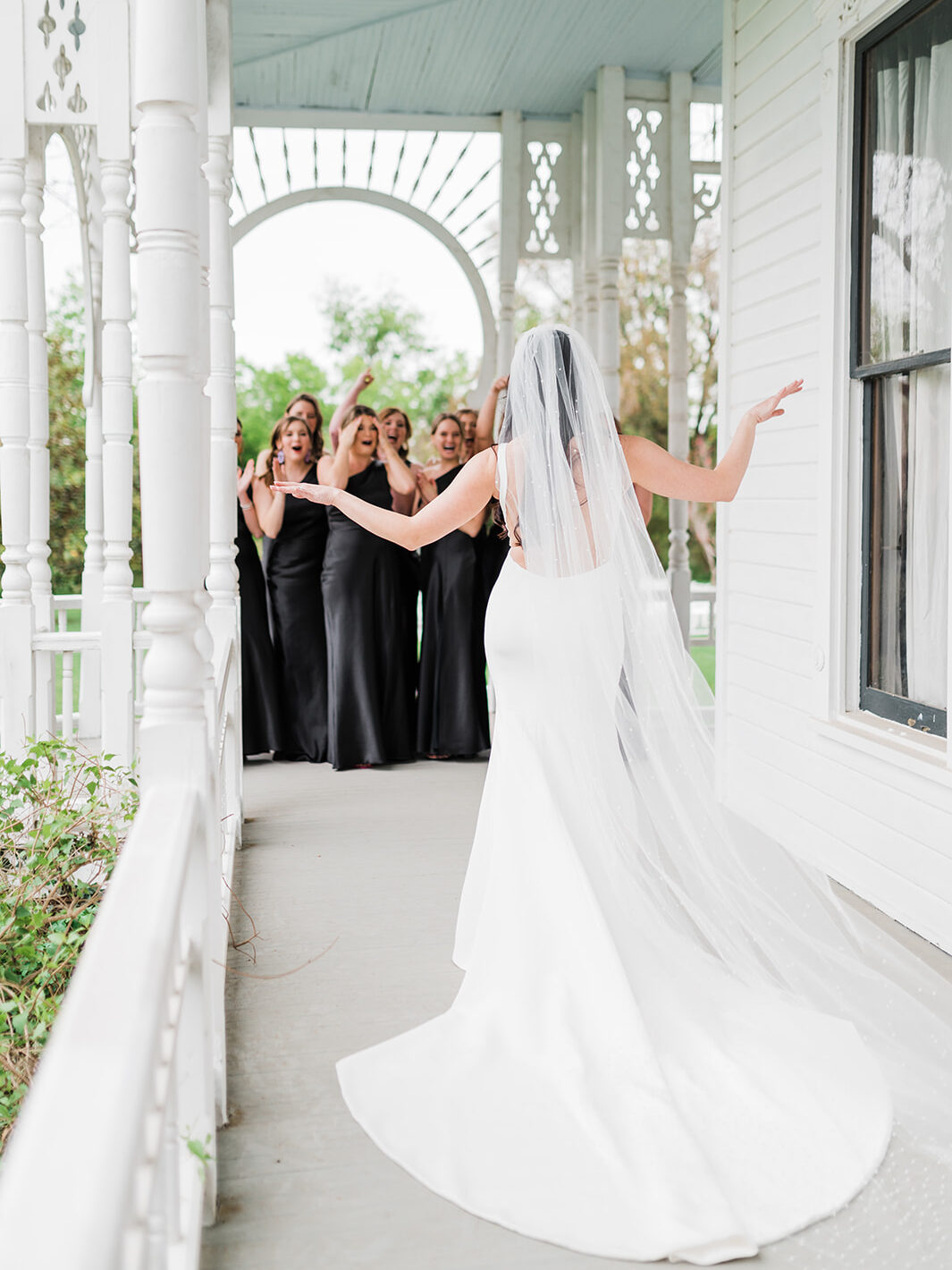Bride revealing her gown to her bridesmaids at Barr Mansion