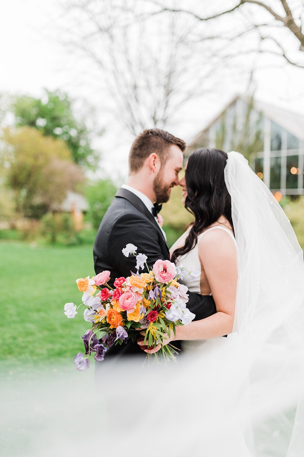 Newlyweds with colorful bridal bouquet