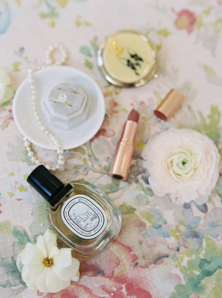 Detail shot of bridal lipstick and perfume