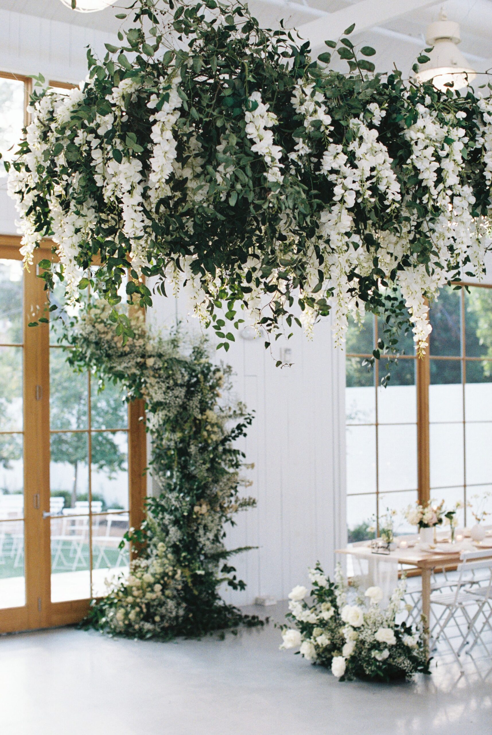Dreamy hanging floral and greenery installation at wedding reception