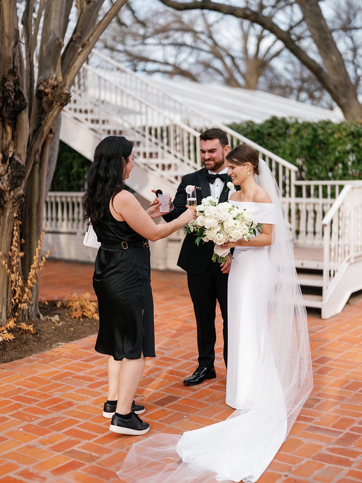 Austin wedding planner handing bride and groom celebratory drinks
