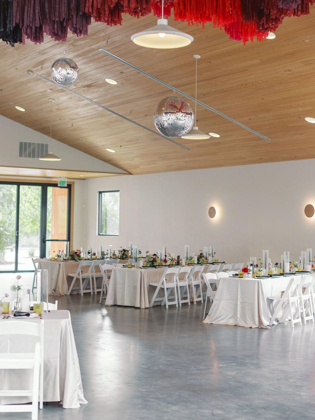 Colorful fall wedding reception at The Grand Lady with disco balls, streamers, colorful flowers and beige linens