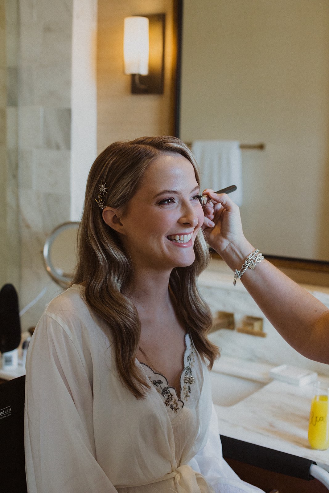 Bride getting her makeup done in the Dewberry Hotel in Charleston