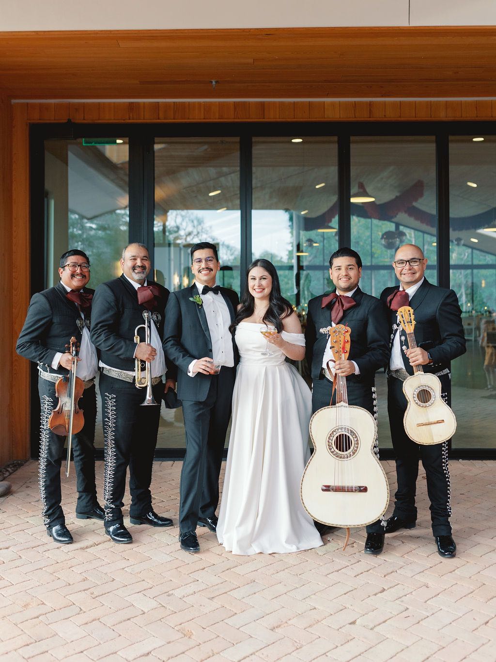 Bride and groom with mariachi band on wedding day