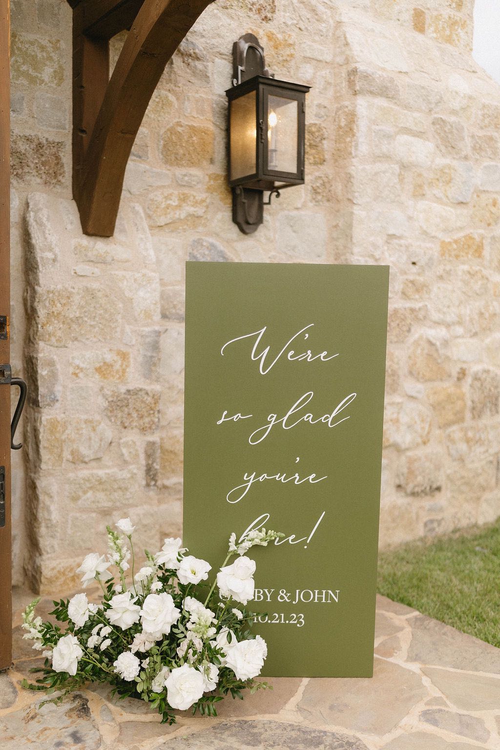 simple green wedding welcome sign with white flowers