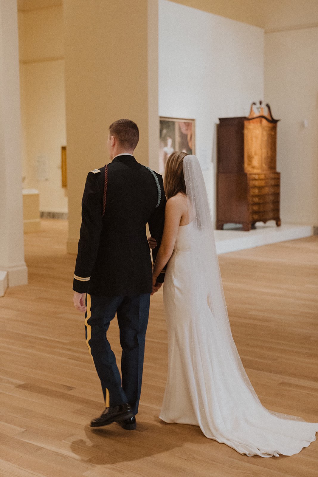 bride and groom walking through the gibbes museum of art in charleston historic district