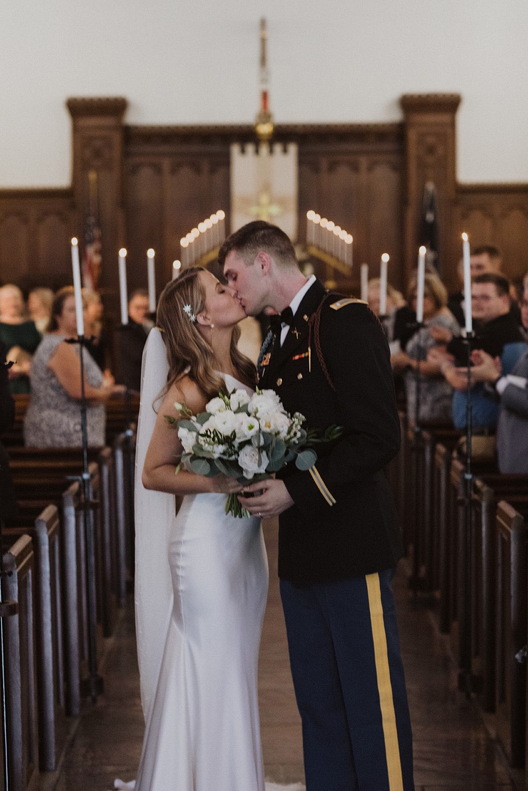 Bride and groom kiss during their recessional at The Citadel Summerall Chapel