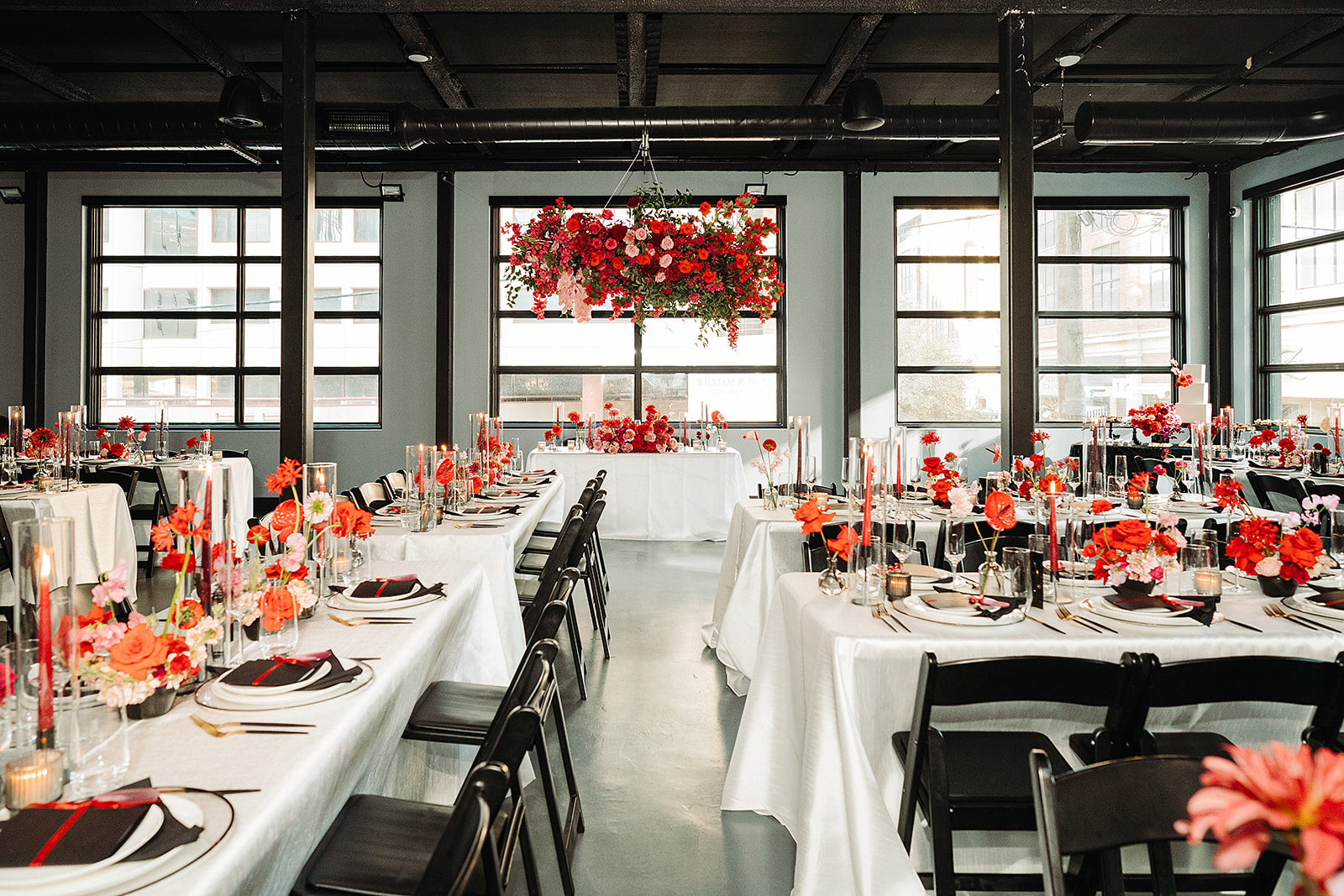 Black and white wedding reception with red and pink flowers in downtown Austin