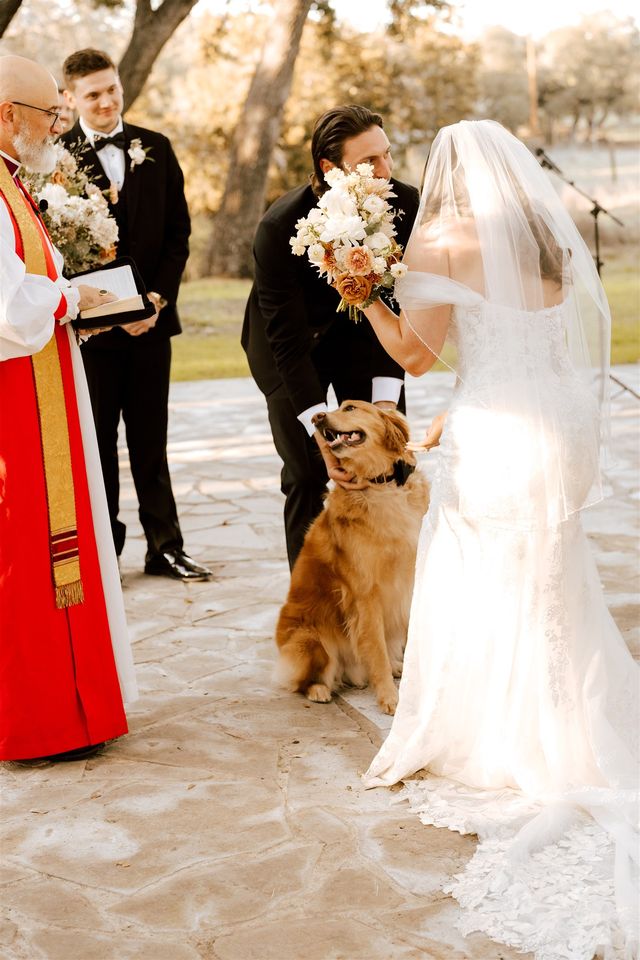 Bride and groom at the altar with their dog