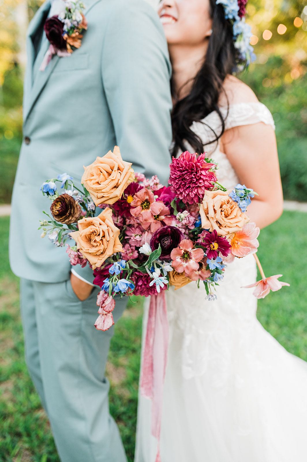 Heart shaped bridal bouquet with berry, mauve, blue and peach flowers