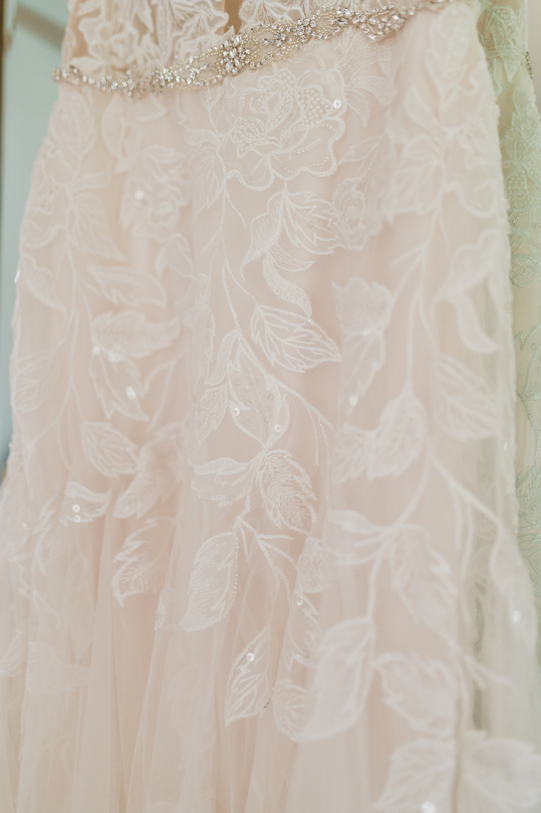 Close up shot of leaf pattern lace wedding dress