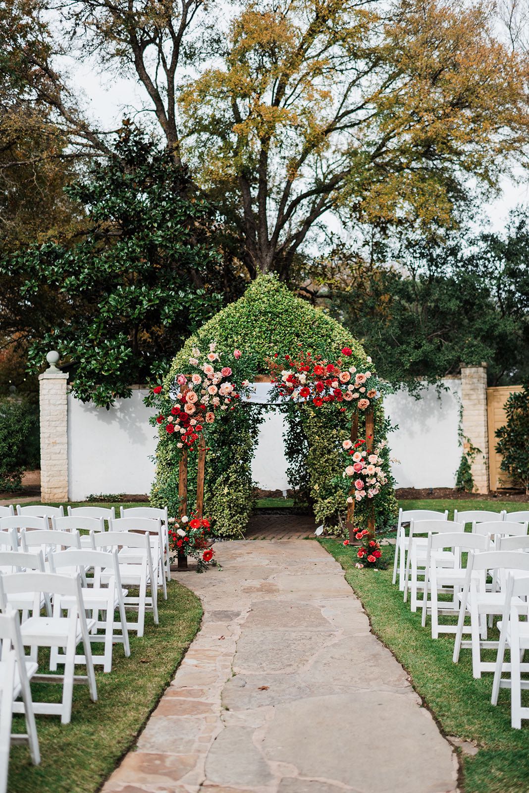 Garden wedding ceremony site with colorful chuppah