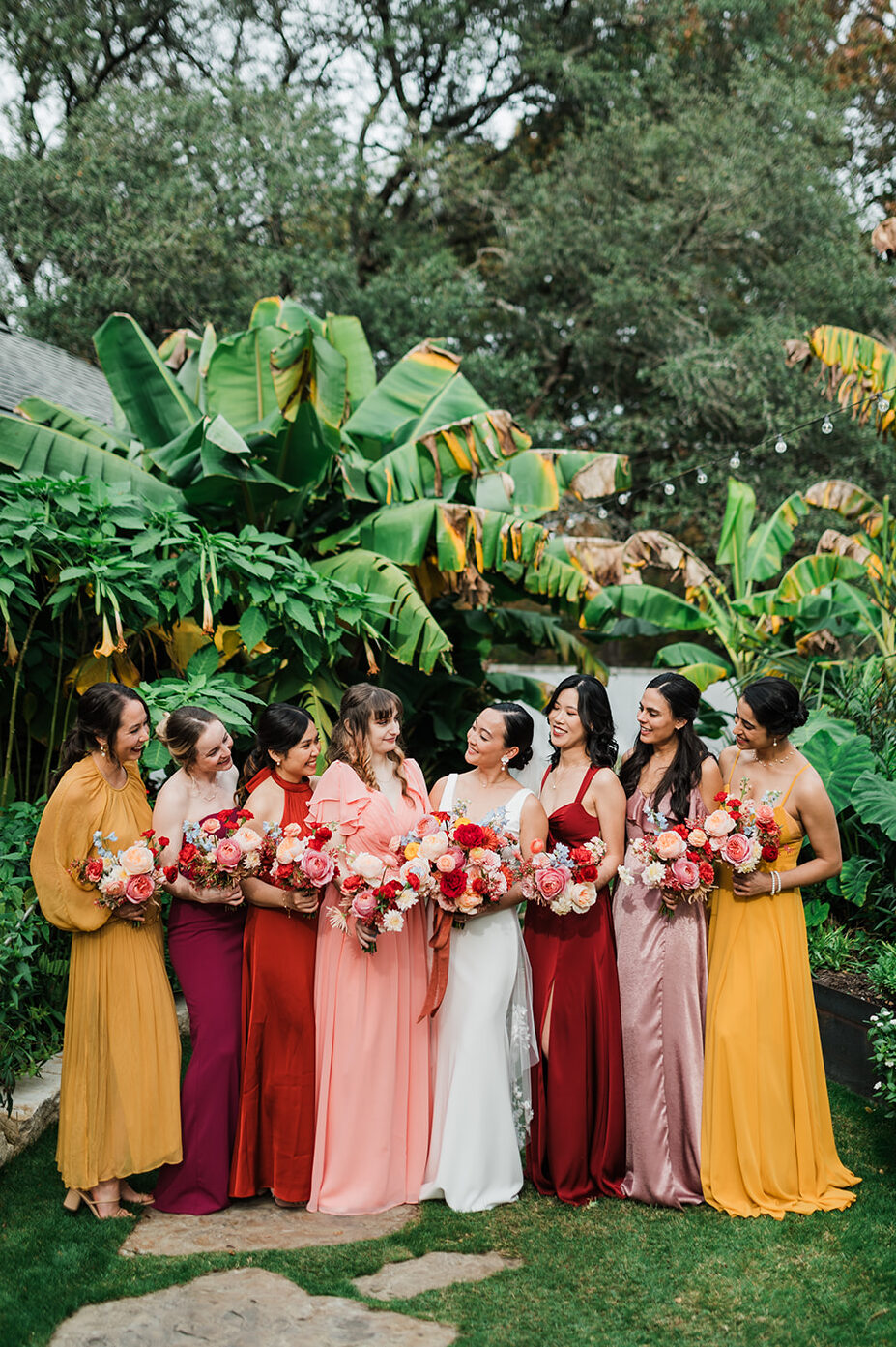 Mismatched bridesmaid dresses in pink, red and yellow