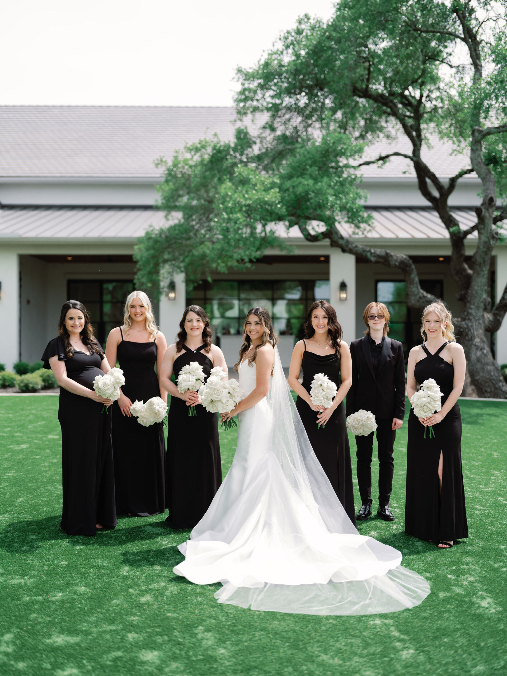 Mixed wedding party with black mismatched dresses and suits