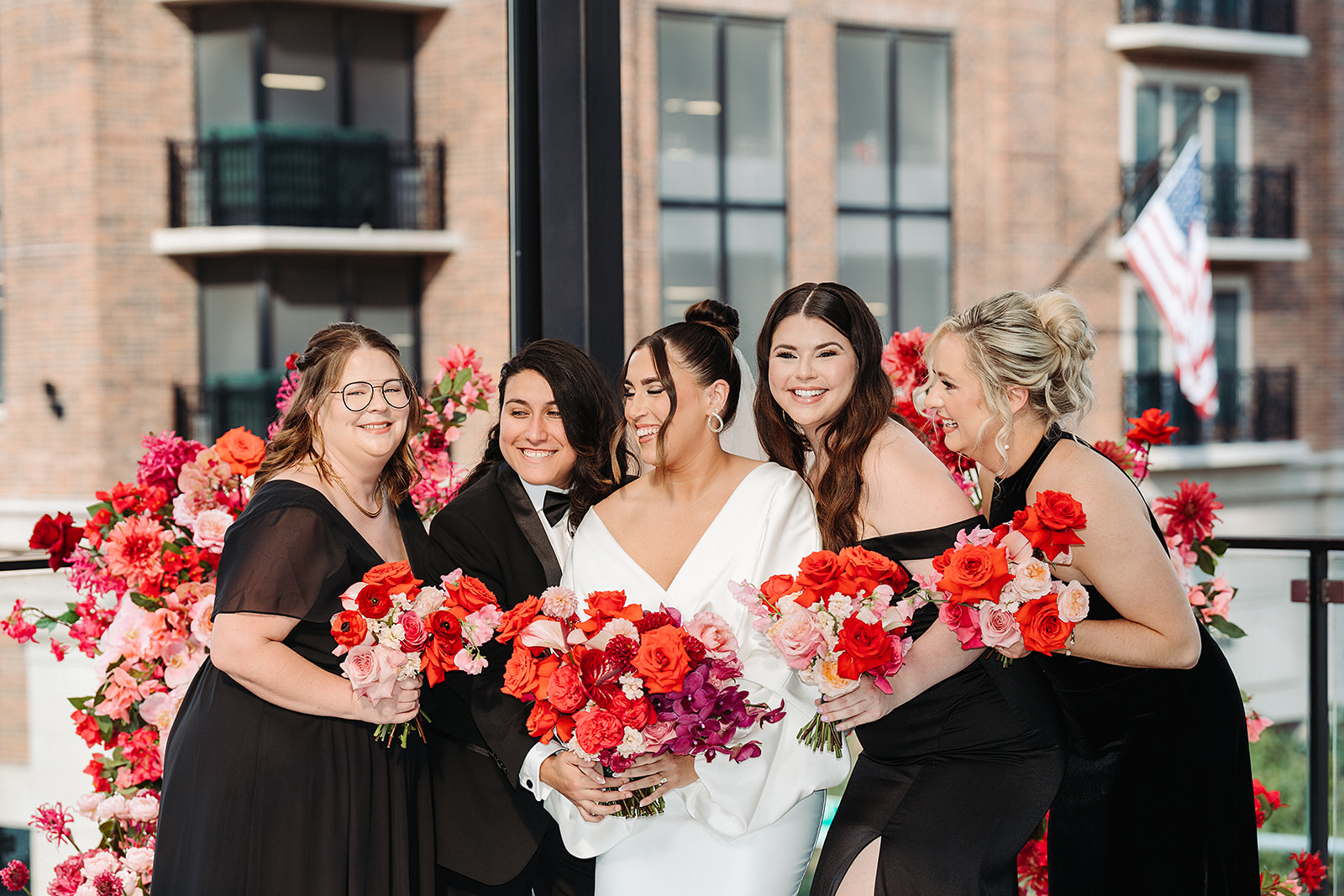 Mixed wedding party with black mismatched dresses and suits