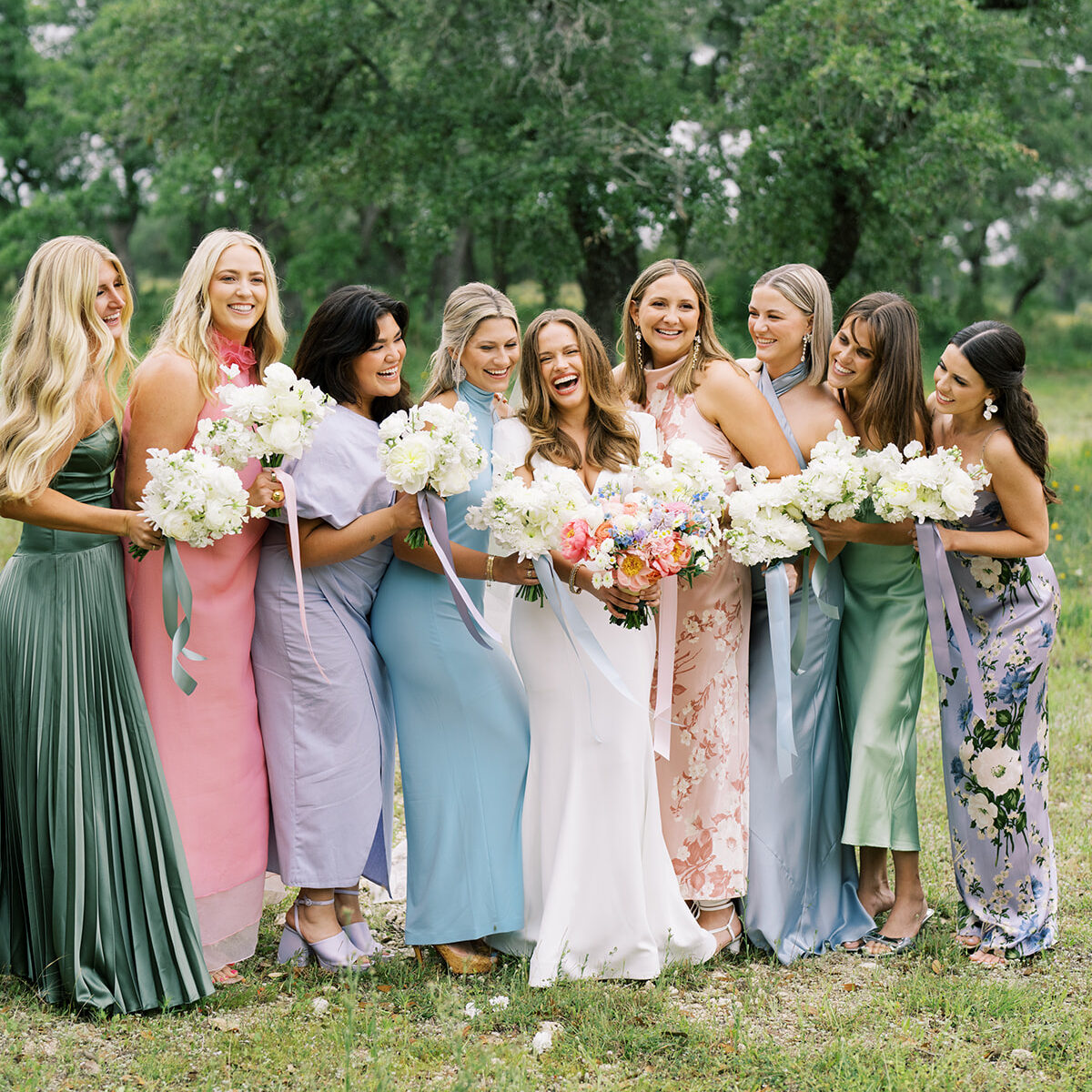 Mismatched bridesmaid dresses in pastel garden colors