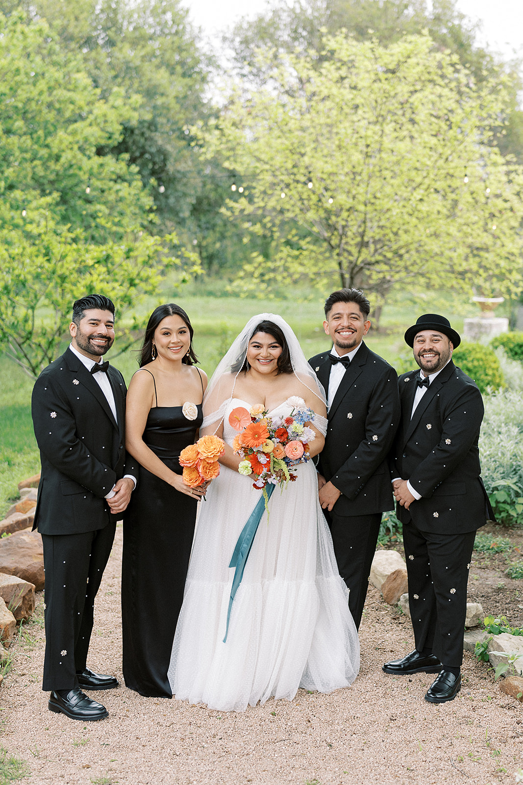 Mixed wedding party with mismatched dresses and bedazzled suits