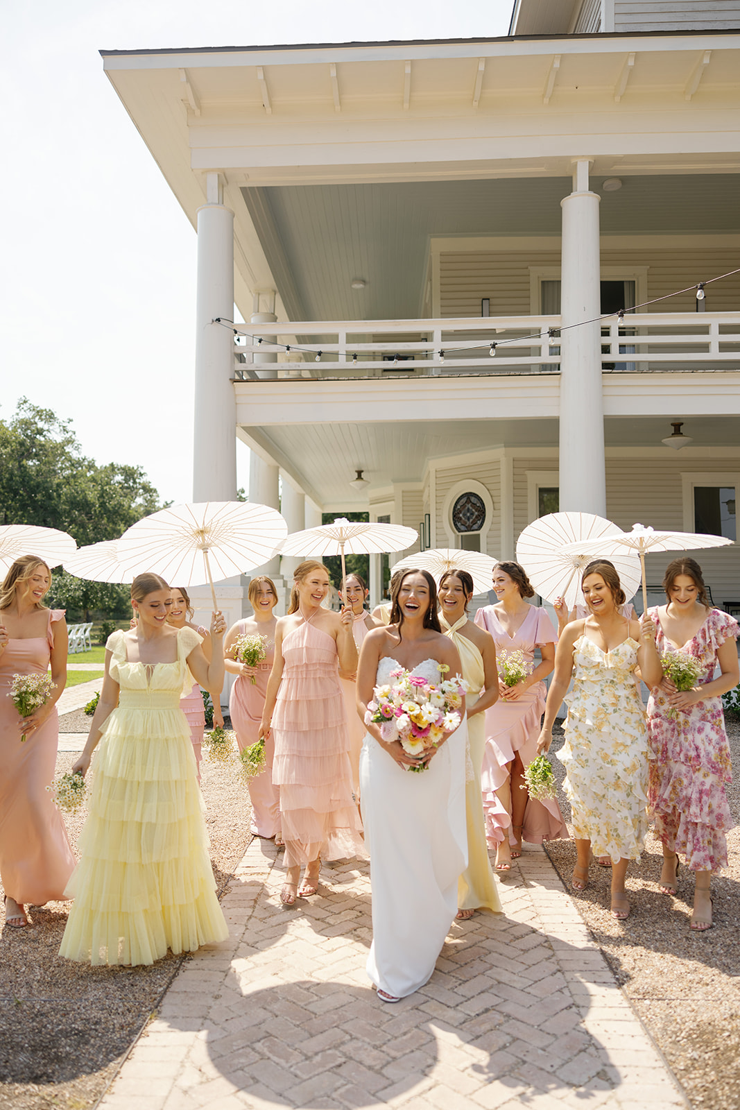 Mismatched bridesmaid dresses in shades of pink and yellow