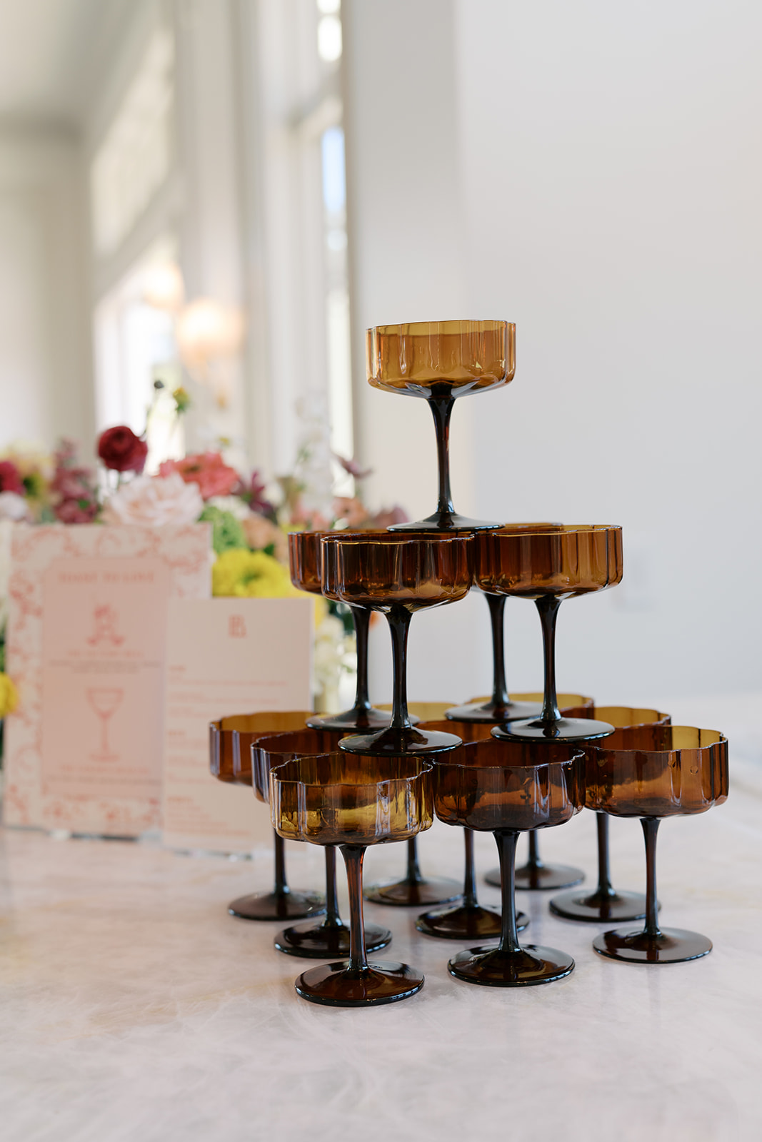 Wedding champagne tower with amber coupe glasses