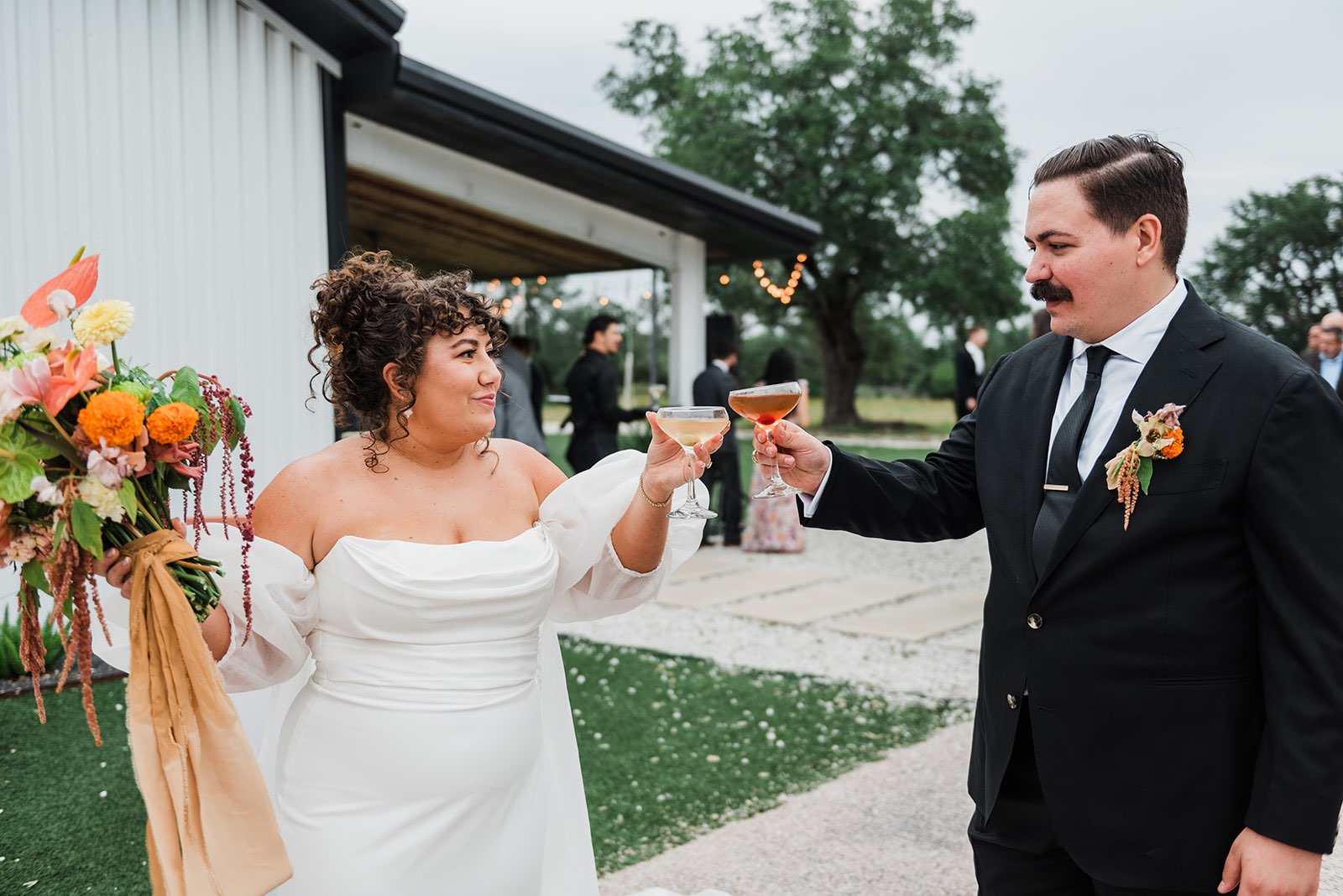 Newlyweds cheers with celebratory martini and old fashioned after ceremony