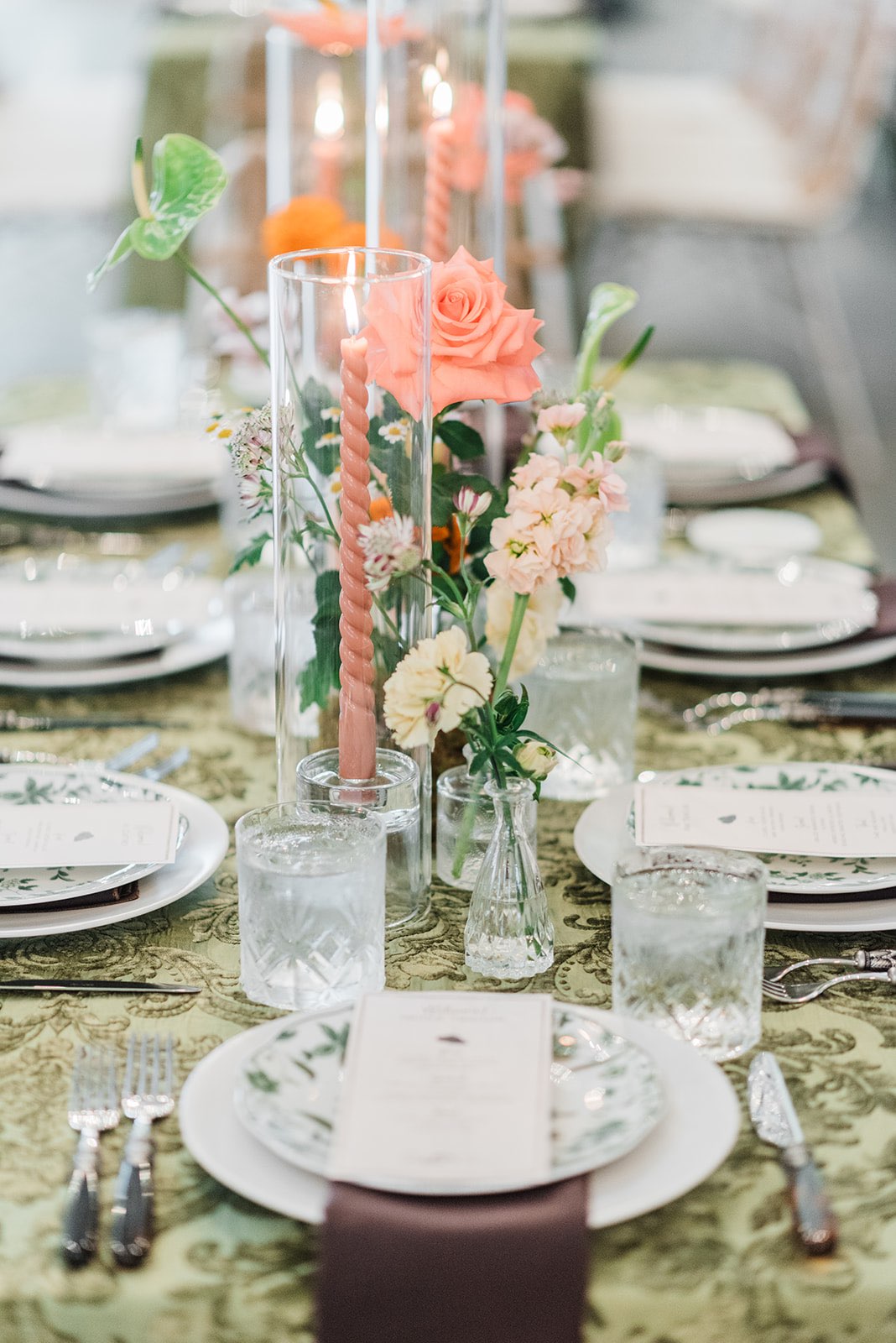 Vintage wedding design tablescape with bright flowers and patterned velvet linens