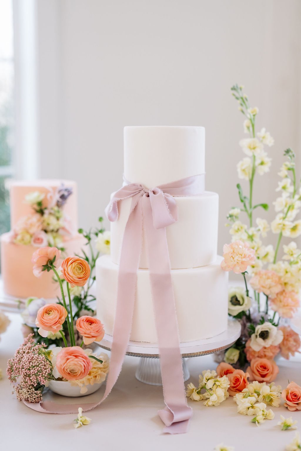 colorful spring wedding cake with lilac bow
