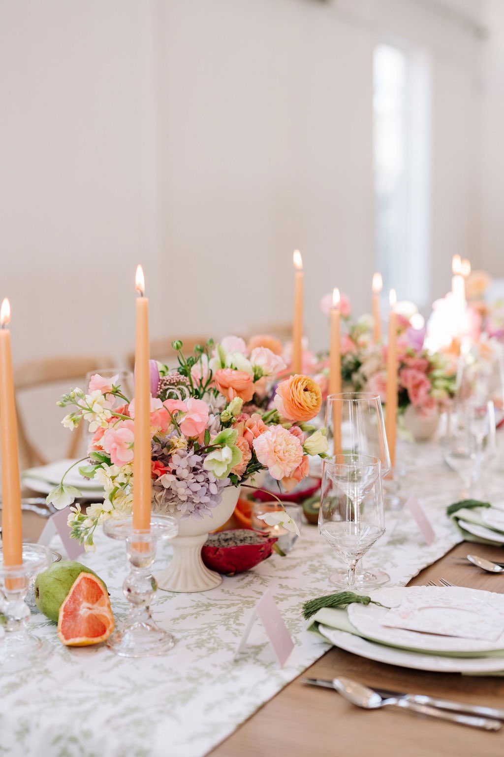 Colorful spring garden wedding table decor with peach candles