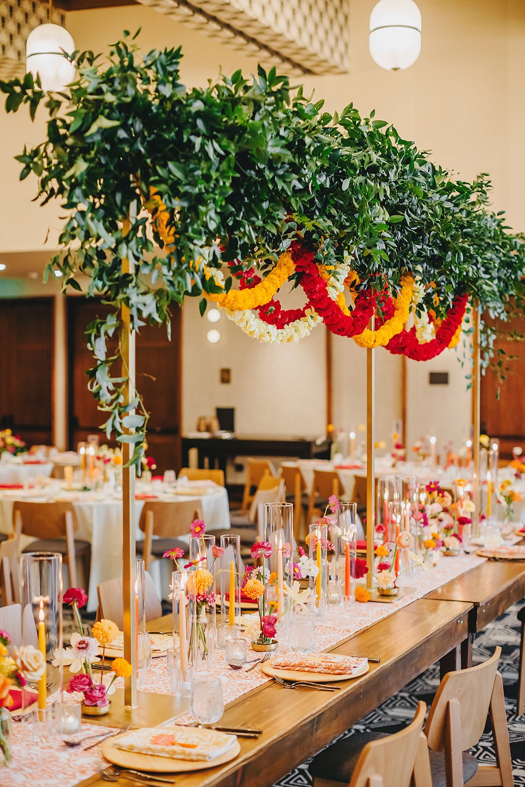 indian fusion wedding reception decor with pink and orange flowers