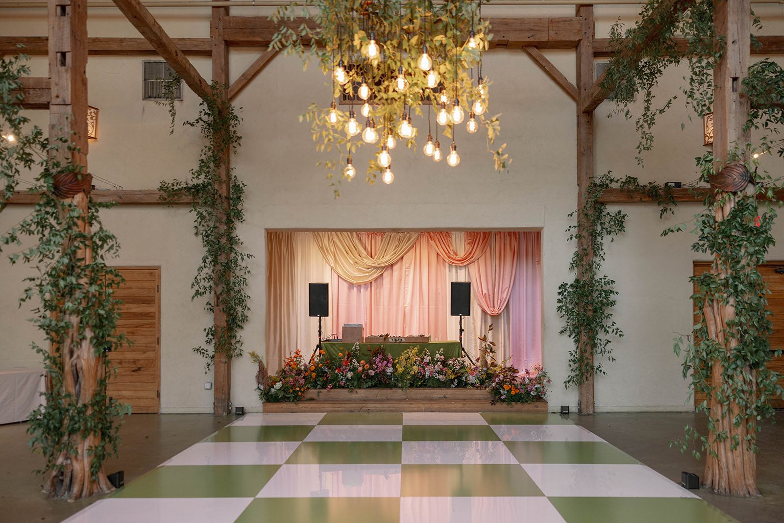 funky, colorful wedding reception with green and white checkered dance floor and stage draping